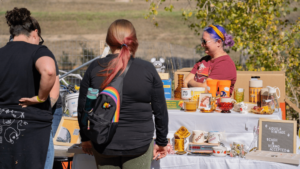 people standing next to stall