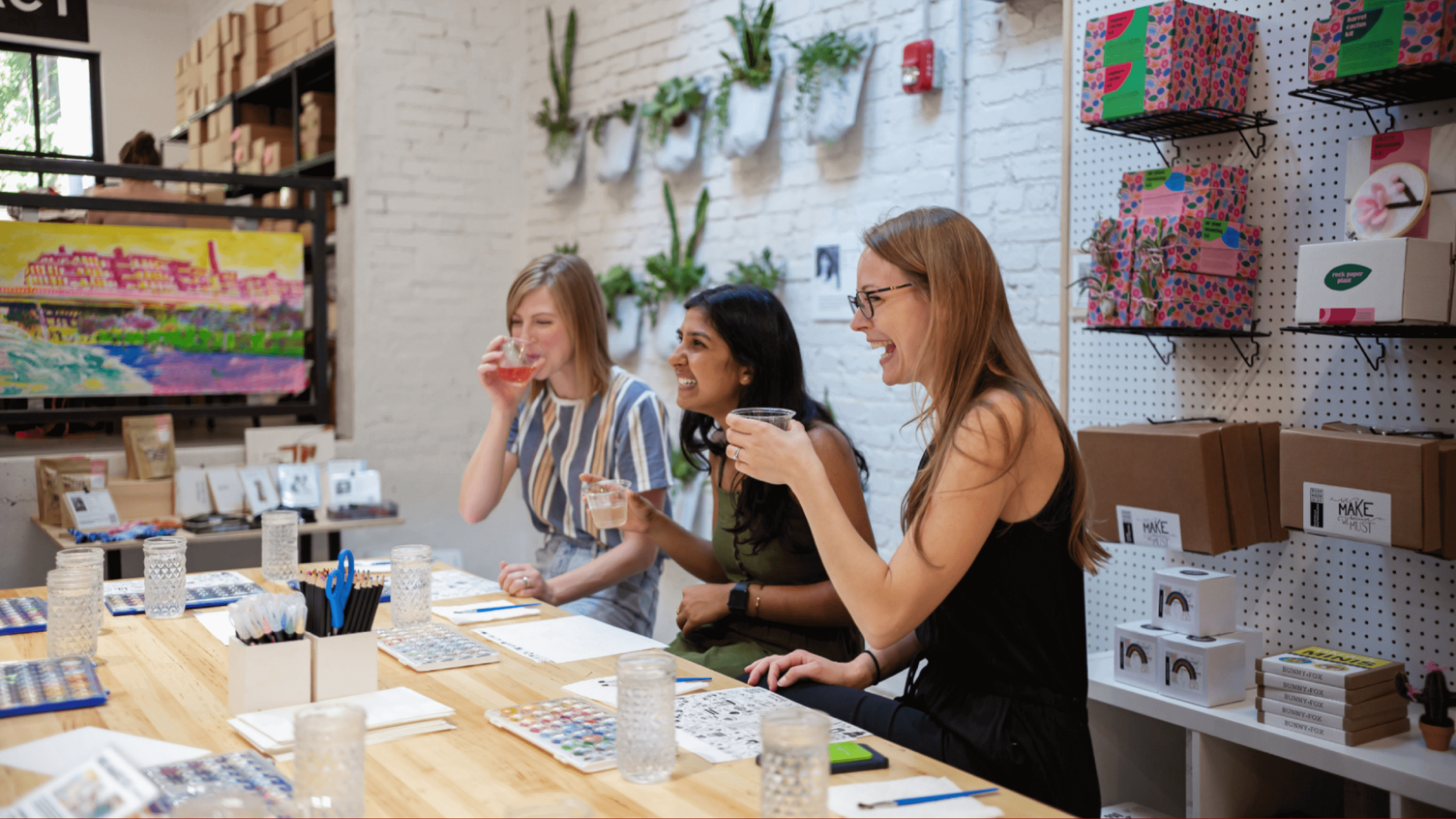 Three women at a sip and paint event