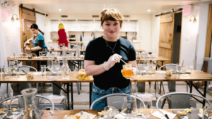 Event organizer prepares tables for Mother's Day event