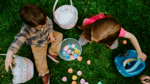 Children sit on ground with Eester baskets