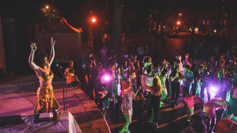 A woman performs onstage for a crowd