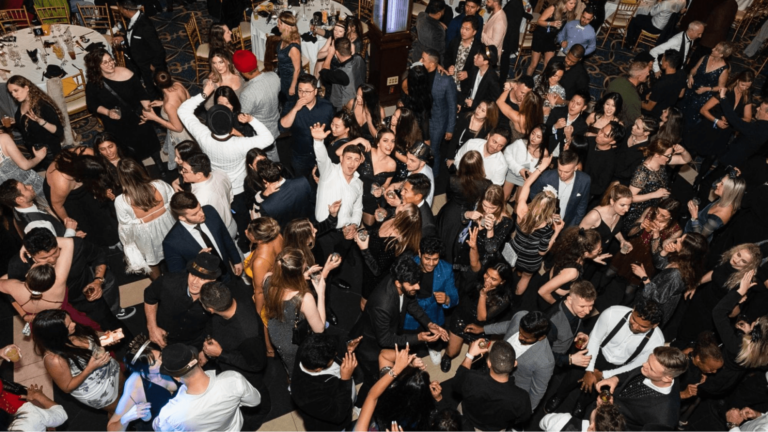 A crowd mingles at a NYE event