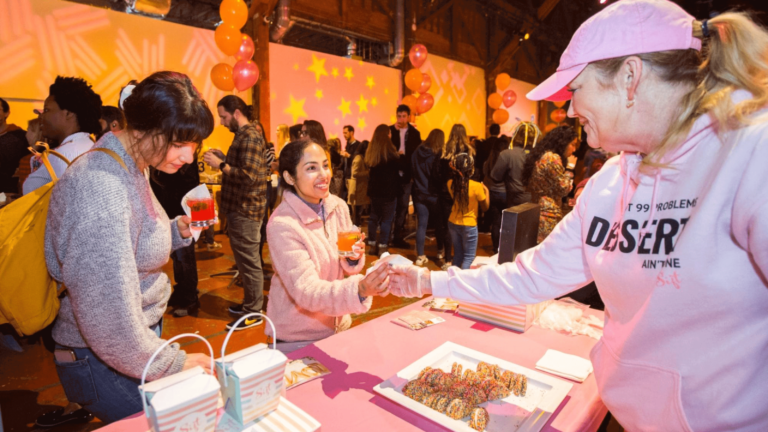 Caterer hands dish to event guest