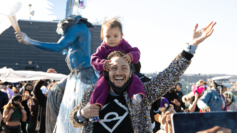 father with kid on shoulders