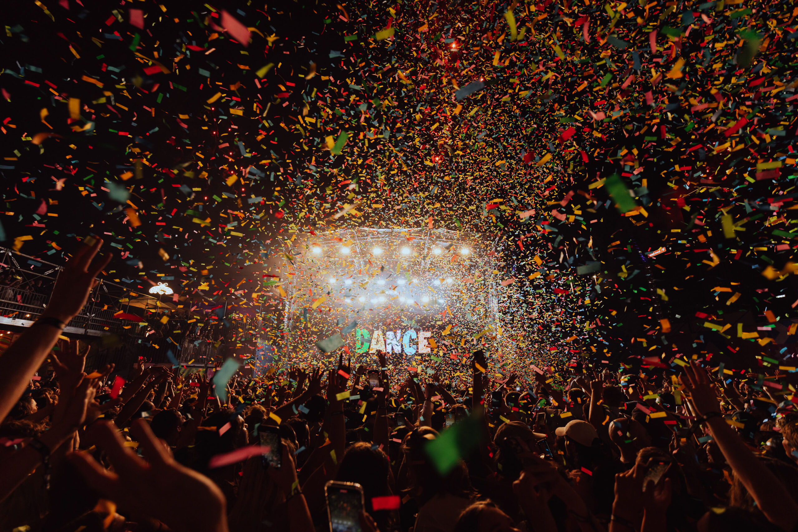 Confetti flying over a stage with a crowd of people at a Bar Pop festival.