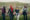 Four women holding hands on a hike during a Muslim Hikers event.