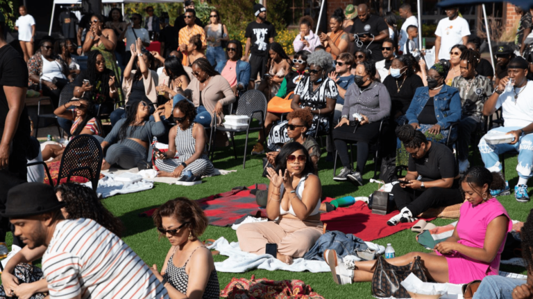 group of people sitting on grass